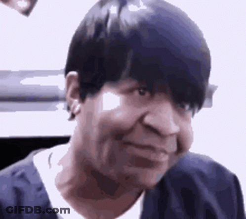 A Close Up Of A Woman 'S Face With Short Black Hair . GIF