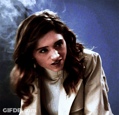 A Close Up Of A Woman 'S Face With Smoke Coming Out Of Her Hair GIF