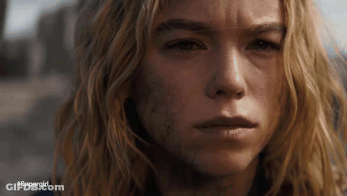 A Close Up Of A Woman 'S Face With #Supergirl Written Below Her GIF