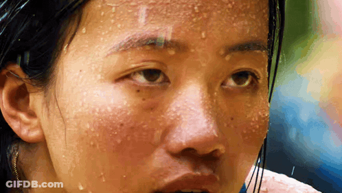 A Close Up Of A Woman 'S Face With Sweat Drops On It GIF