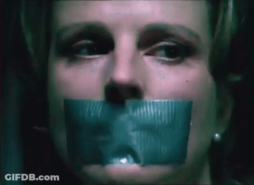 A Close Up Of A Woman 'S Face With Tape On Her Mouth GIF