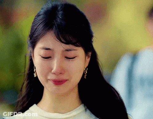 A Close Up Of A Woman 'S Face With Tears Coming Out Of Her Eyes GIF
