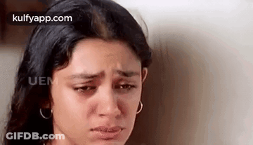 A Close Up Of A Woman 'S Face With Tears Coming Out Of Her Eyes . GIF
