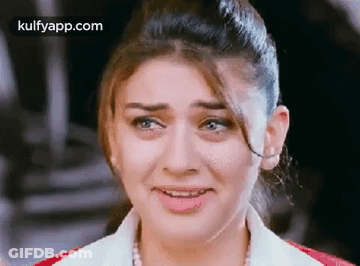 A Close Up Of A Woman 'S Face With Tears Coming Out Of Her Eyes . GIF