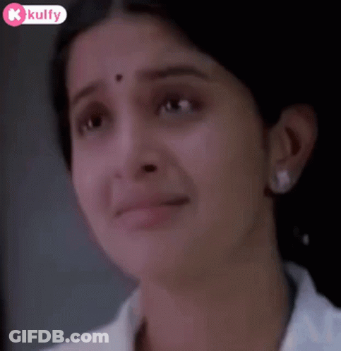 A Close Up Of A Woman 'S Face With Tears Coming Out Of Her Eyes . GIF