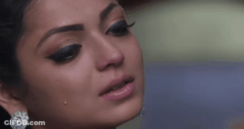 A Close Up Of A Woman 'S Face With Tears Coming Out Of Her Eyes . GIF