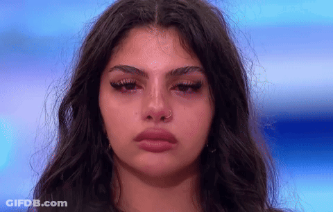 A Close Up Of A Woman 'S Face With Tears Coming Out Of Her Eyes GIF