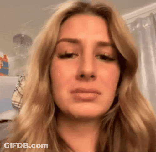 A Close Up Of A Woman 'S Face With Tears Running Down Her Cheeks GIF