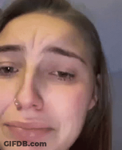 A Close Up Of A Woman 'S Face With Tears Running Down Her Cheeks . GIF