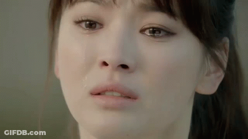 A Close Up Of A Woman 'S Face With Tears Running Down Her Face . GIF