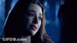 A Close Up Of A Woman 'S Face With Tears Running Down Her Face . GIF