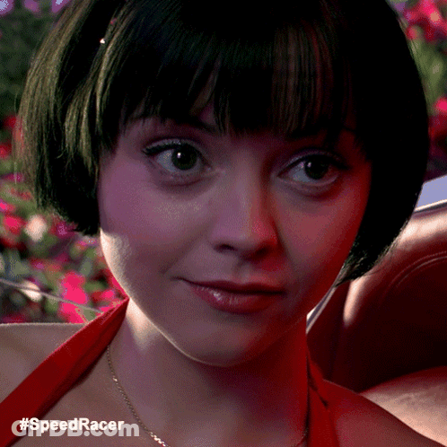 A Close Up Of A Woman 'S Face With The Hashtag #Speedracer Below Her GIF