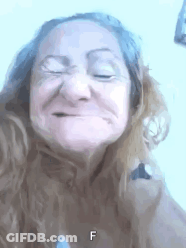 A Close Up Of A Woman 'S Face With The Letter F Visible GIF