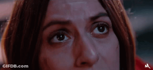 A Close Up Of A Woman 'S Face With The Letter M On The Bottom GIF