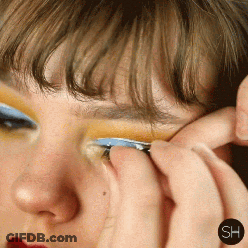 A Close Up Of A Woman 'S Face With The Letters Sh On The Bottom Right GIF