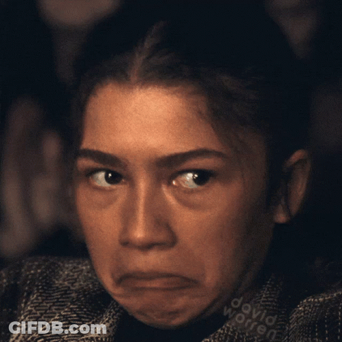 A Close Up Of A Woman 'S Face With The Name David Worren Written On Her Shirt GIF
