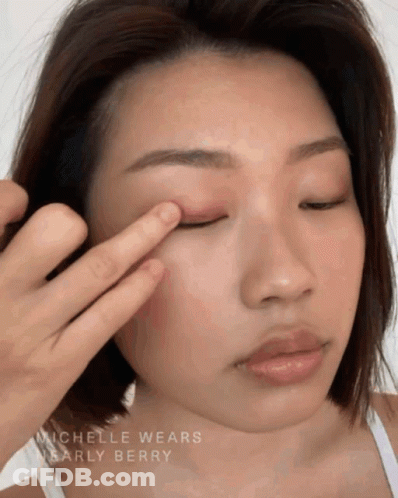 A Close Up Of A Woman 'S Face With The Name Michelle Wears Nearly Berry On The Bottom GIF