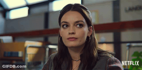 A Close Up Of A Woman 'S Face With The Netflix Logo In The Corner GIF