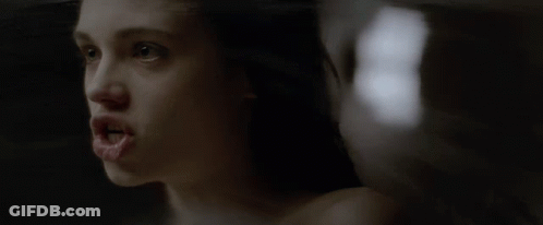A Close Up Of A Woman 'S Face With The Number 8 In The Background GIF