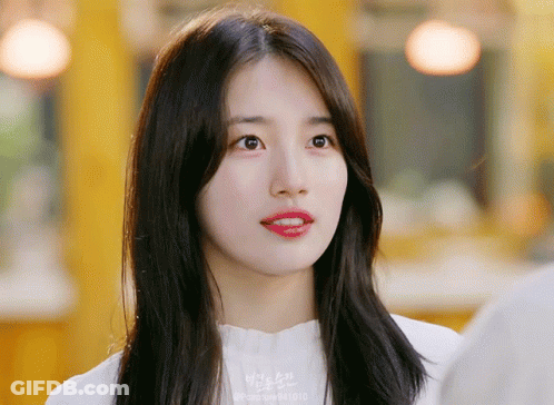 A Close Up Of A Woman 'S Face With The Number 841013 On Her Shirt GIF