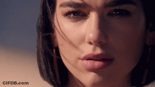 A Close Up Of A Woman 'S Face With The Sun Shining On Her Face GIF