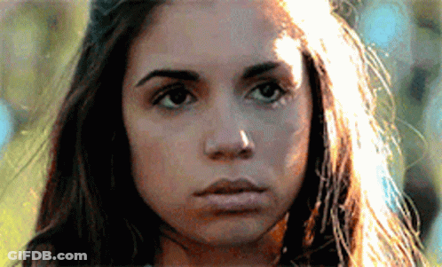 A Close Up Of A Woman 'S Face With The Sun Shining On Her Hair GIF