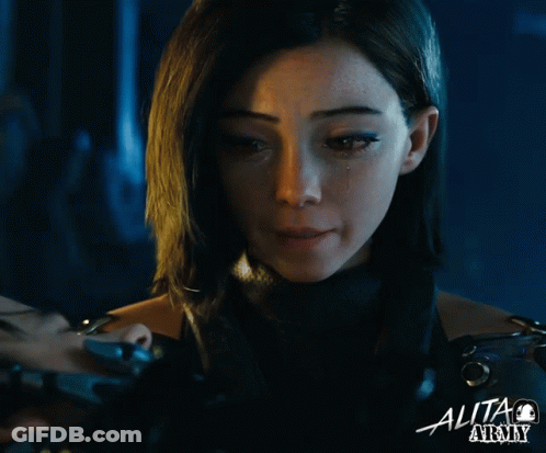 A Close Up Of A Woman 'S Face With The Word Alita On The Bottom Right GIF