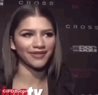 A Close Up Of A Woman 'S Face With The Word Cross On The Bottom GIF