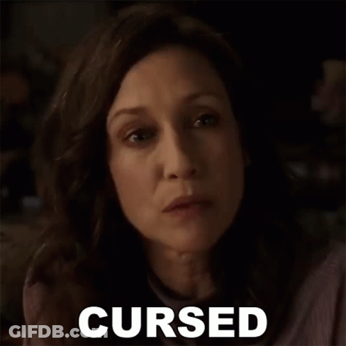 A Close Up Of A Woman 'S Face With The Word Cursed Written Next To Her . GIF