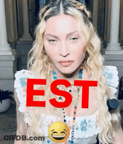 A Close Up Of A Woman 'S Face With The Word Est In Red GIF