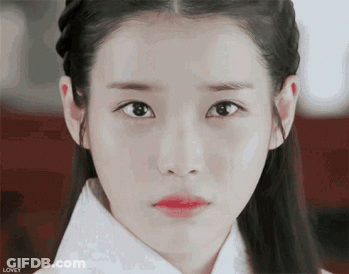 A Close Up Of A Woman 'S Face With The Word Lovey On The Bottom Left GIF