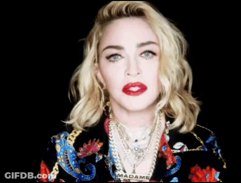 A Close Up Of A Woman 'S Face With The Word Madame On Her Neck GIF