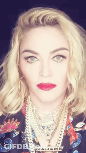 A Close Up Of A Woman 'S Face With The Word Madame Visible GIF