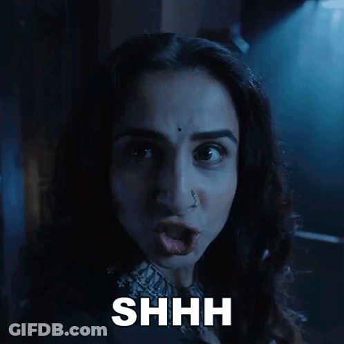 A Close Up Of A Woman 'S Face With The Word Shhh Above Her GIF