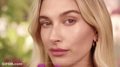 A Close Up Of A Woman 'S Face With The Words " 100 % Of Users Win " Behind Her GIF