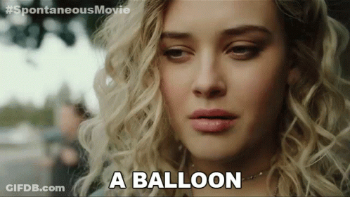 A Close Up Of A Woman 'S Face With The Words " A Balloon " Next To Her GIF