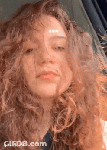 A Close Up Of A Woman 'S Face With The Words Amo On Her Forehead GIF