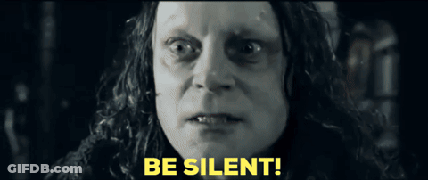 A Close Up Of A Woman 'S Face With The Words Be Silent In Yellow Letters GIF