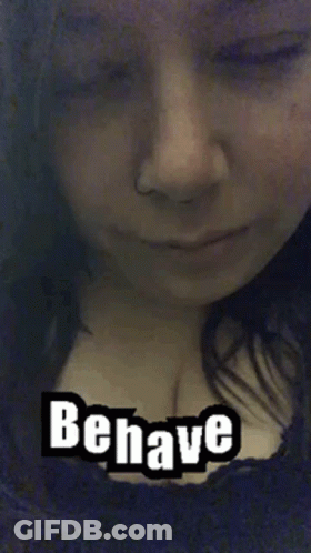 A Close Up Of A Woman 'S Face With The Words Behave Written On It . GIF