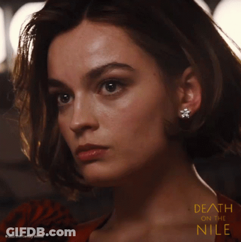 A Close Up Of A Woman 'S Face With The Words Death On The Nile GIF