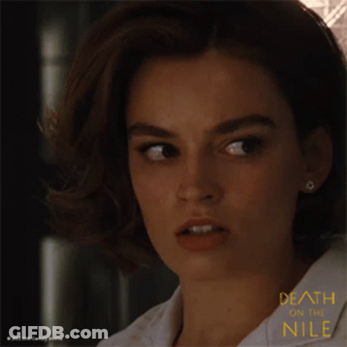 A Close Up Of A Woman 'S Face With The Words Death On The Nile GIF
