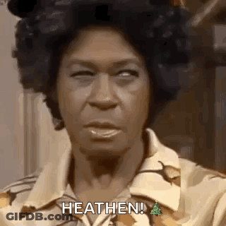 A Close Up Of A Woman 'S Face With The Words `` Heathen '' Written On It . GIF