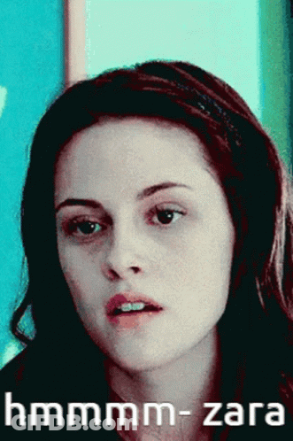 A Close Up Of A Woman 'S Face With The Words Hmmmm-Zara Written Below Her GIF