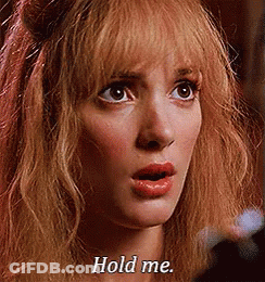 A Close Up Of A Woman 'S Face With The Words `` Hold Me '' Written On Her Face . GIF