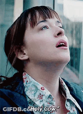 A Close Up Of A Woman 'S Face With The Words `` Holy Cow '' Written On The Bottom . GIF