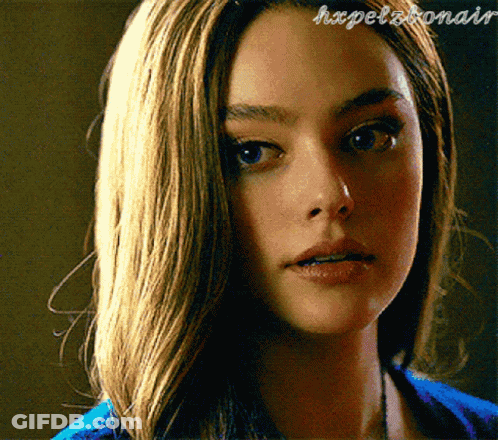 A Close Up Of A Woman 'S Face With The Words Hxpelbonair Written On The Bottom GIF