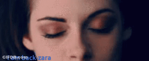 A Close Up Of A Woman 'S Face With The Words " I Am Back Zara " Above Her GIF