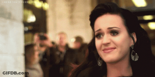 A Close Up Of A Woman 'S Face With The Words " I Heart Katy Perry " Written On The Bottom GIF