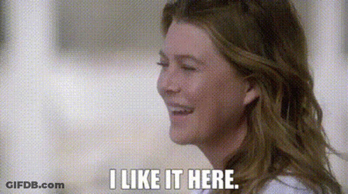 A Close Up Of A Woman 'S Face With The Words `` I Like It Here '' Written On It . GIF