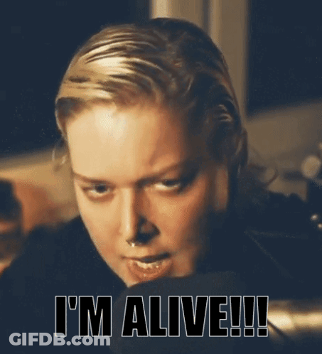 A Close Up Of A Woman 'S Face With The Words I 'M Alive Written Below Her GIF